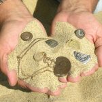 монеты и ценности в песке